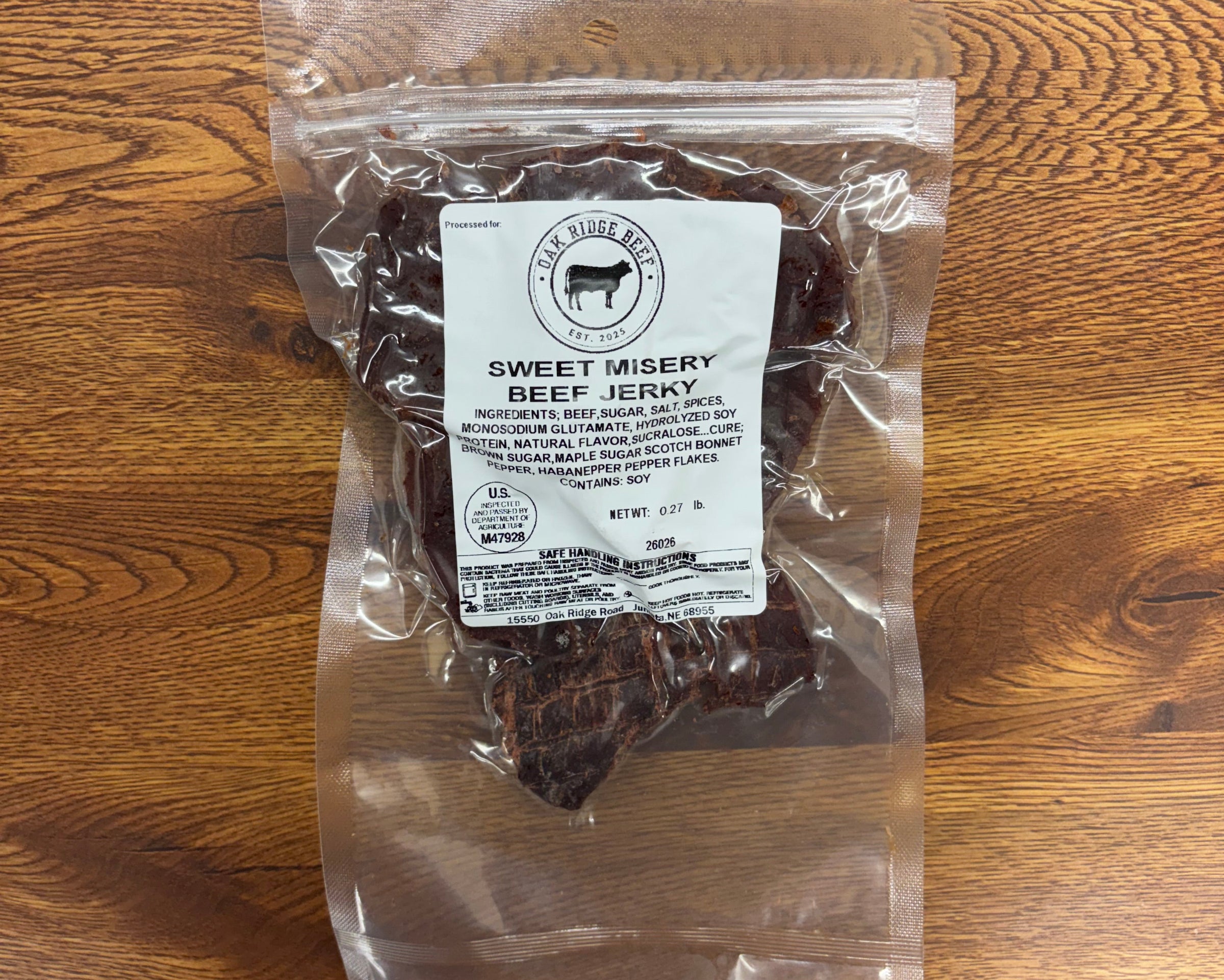 Packaged product on a wooden surface with a visible label.